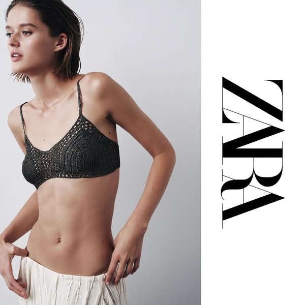 A high-fashion studio shot featuring a crochet bralette, utilizing negative space and strong brand typography to highlight product texture.